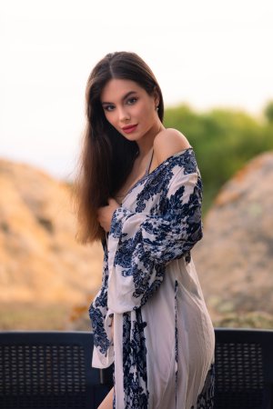 Liz Ocean in blue floral robe posing solo on balcony lounge chair with red lips and lace lingerie — Liz Ocean #1