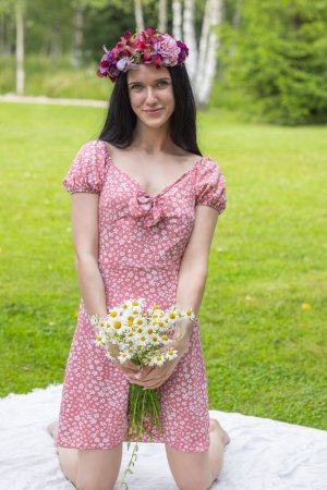 Posy, black hair and flower crown, posing nude on white blanket in grass, solo outdoor tease — Posy #1