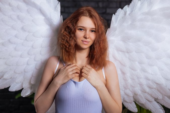 Miama teases in angel wings, stripping her lingerie slow on the brown couch, solo and nude — Miama #3