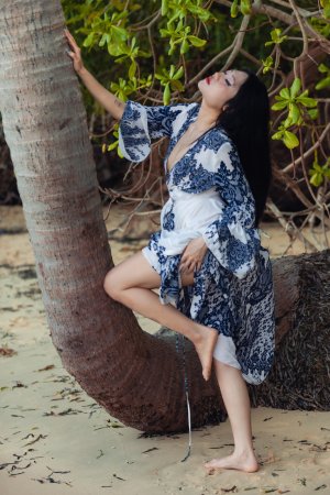 May starts poised in robe then bares all under palms her body telling a slow tease story — May #3