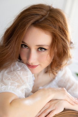 Alice Mido teases in white lingerie sprawled across the blue chair her curves on full display — Alice Mido #2
