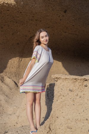 Bozhena bares all in a white dress at the cave, topless poses with flip flops on sunlit rocks — Bozhena #2