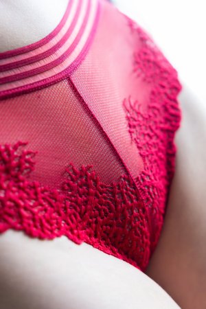 HELGA MAIER in red lace posing on blue armchair skin glowing under soft light curves on display — HELGA MAIER #2