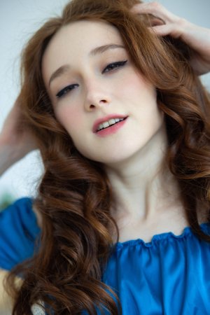 Alice Mido in blue silk, topless posing on wicker chair, curly redhead teasing her curves — Alice Mido #4