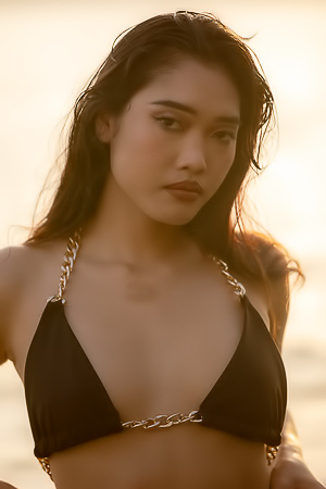 Minari bares all in the sea at sunset, posing nude with hands on her body, smiling
