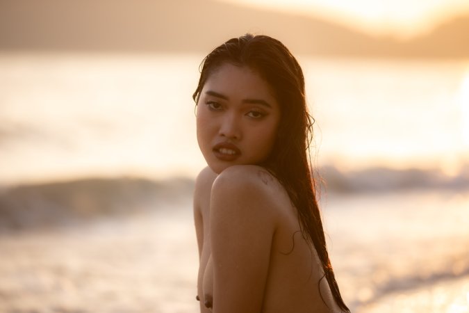 Minari bares all in the sea at sunset, posing nude with hands on her body, smiling — Minari #13