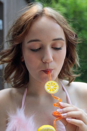 Rokki teases in feathered pink lace outdoors, sipping slow with sun on her skin, solo and soft — Rokki #2