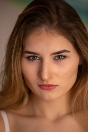 Lorelei posing nude and in floral lingerie on a cushioned bench in a bright bedroom setting — Lorelei #3