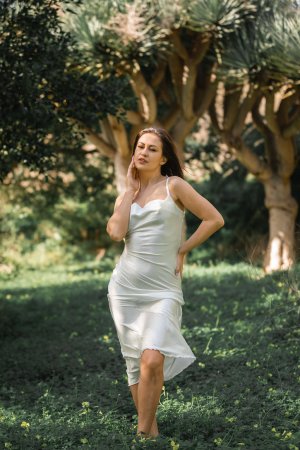 Demi Fray kneels bare in dappled forest light her white fabric slipping as she poses for your gaze — Demi Fray #1